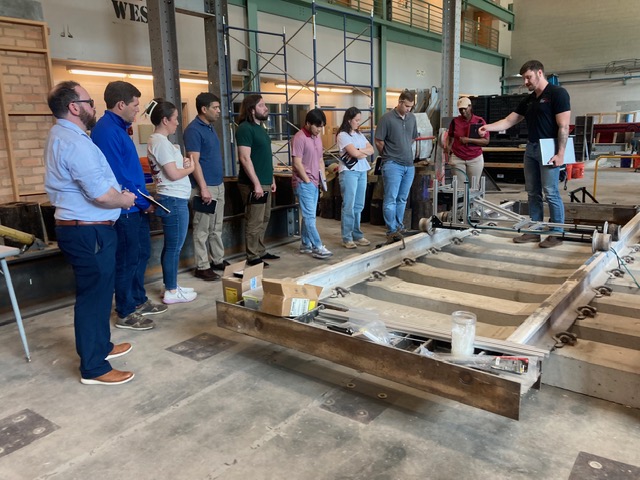 Group of people standing together in a warehouse